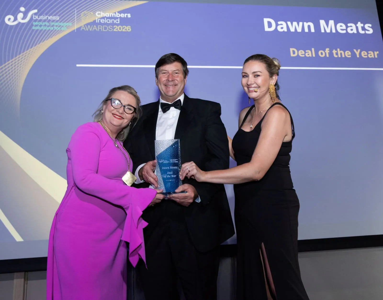 An award being presented at a black-tie business awards ceremony