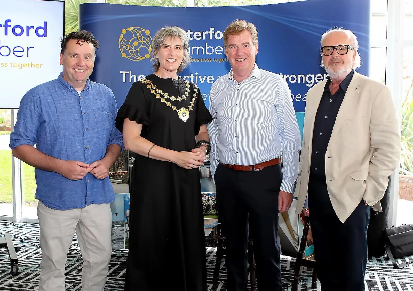 Members in front of a Waterford Chamber banner about the collective voice of business